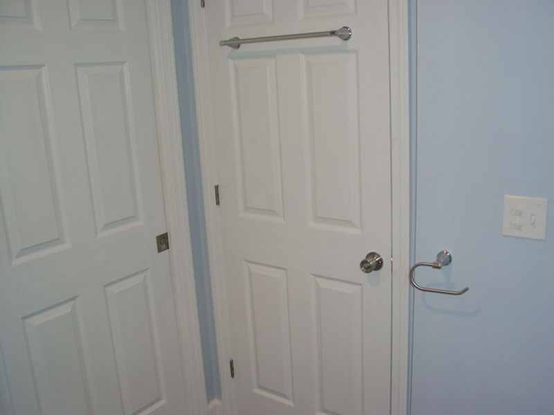 Linen closet in new bath with towel racks. Note the sliding door for entrance, saving space