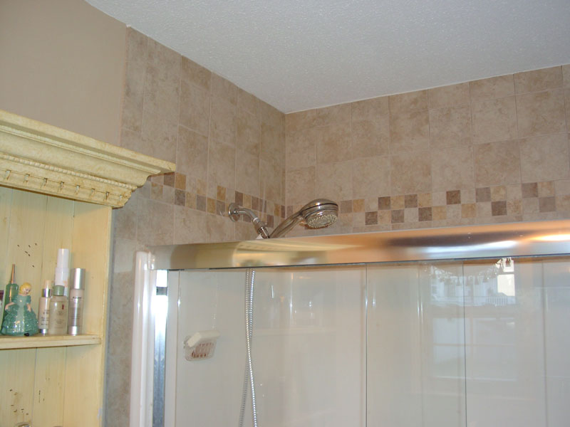 New tile with tile accent above the shower matches the floor.