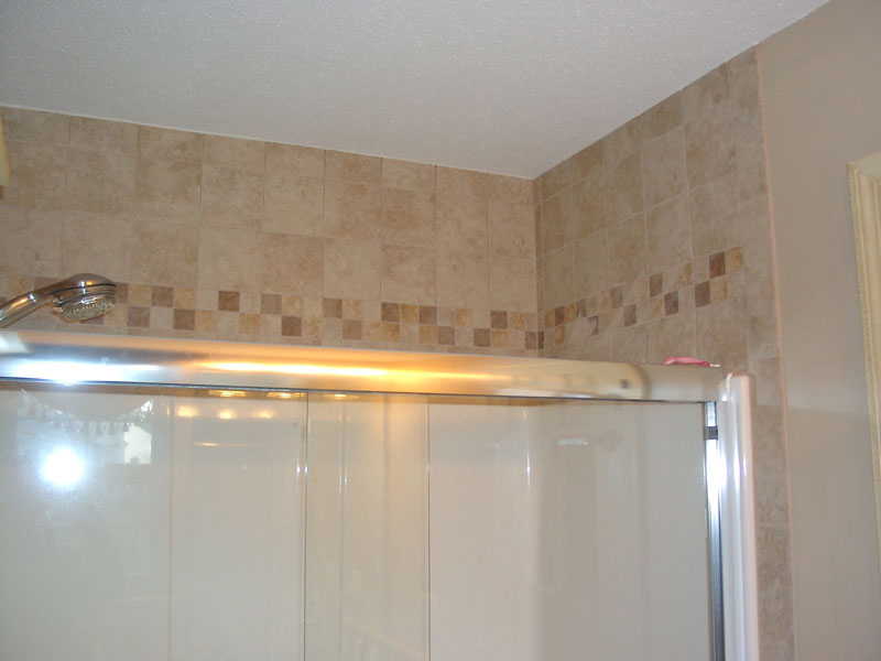 Tile accent continues all around upgraded shower.