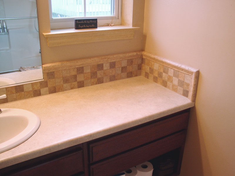 Tile accent in the back splash above sink and vanity area.
