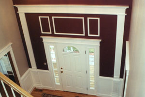 A Wainscot and chair rail on the wall, together with wood molding accents provide an entry highlight